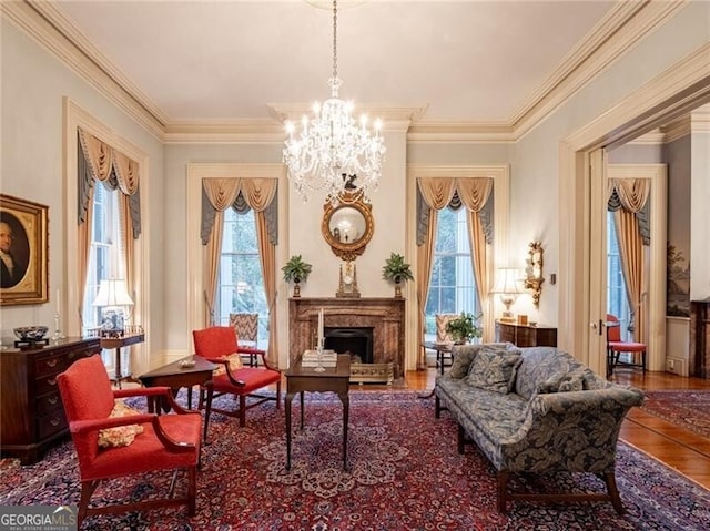 living area featuring hardwood / wood-style floors, a wealth of natural light, and ornamental molding