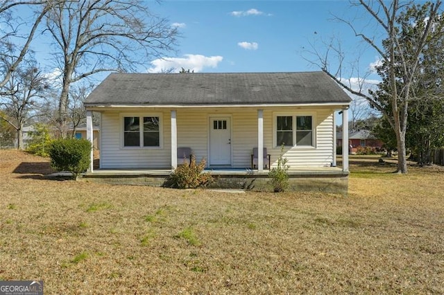 bungalow-style house featuring a porch and a front yard