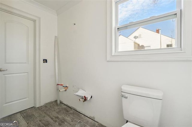 bathroom featuring hardwood / wood-style floors and toilet