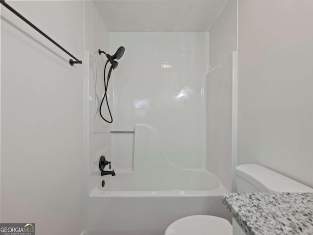 bathroom with tiled shower / bath combo, a textured ceiling, and toilet