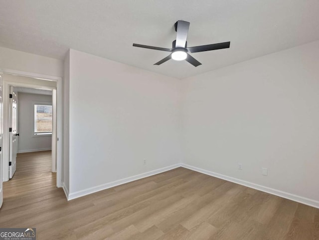 unfurnished room with ceiling fan and light hardwood / wood-style floors