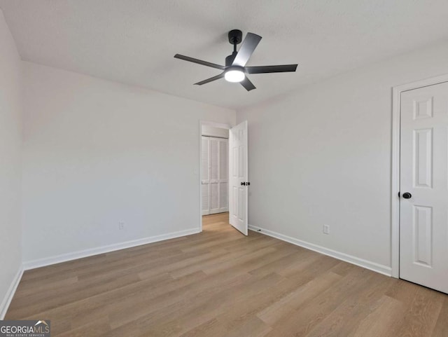 unfurnished bedroom with ceiling fan and light hardwood / wood-style floors