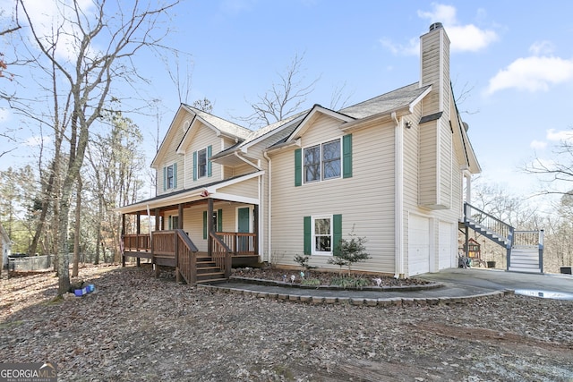 view of front of property featuring a garage and a porch