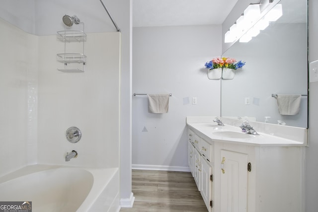 bathroom featuring vanity, wood-type flooring, and bathtub / shower combination