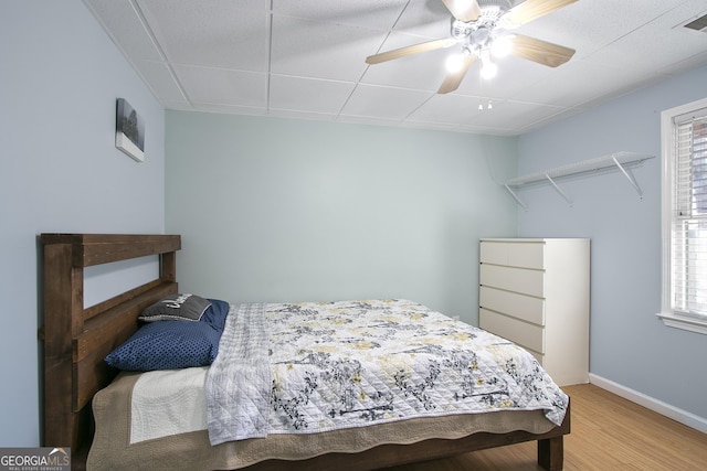 bedroom featuring hardwood / wood-style flooring and ceiling fan