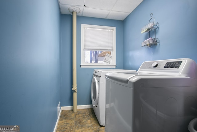 clothes washing area featuring independent washer and dryer