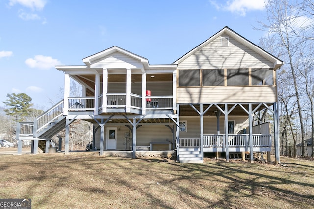 view of front of home featuring a sunroom, a jacuzzi, and a front yard