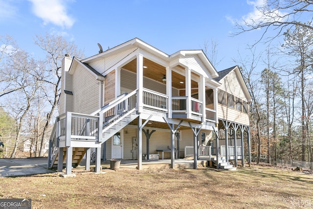 view of side of property with a patio, a sunroom, and ceiling fan