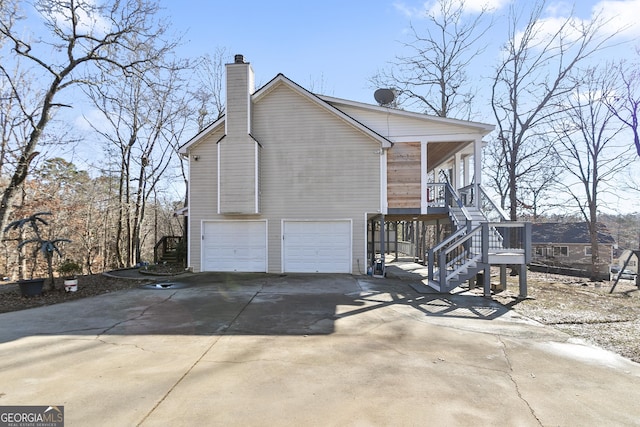 view of home's exterior with a garage and covered porch