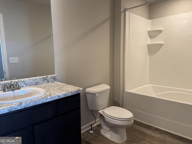 full bathroom with wood-type flooring, toilet, shower / bathing tub combination, and vanity