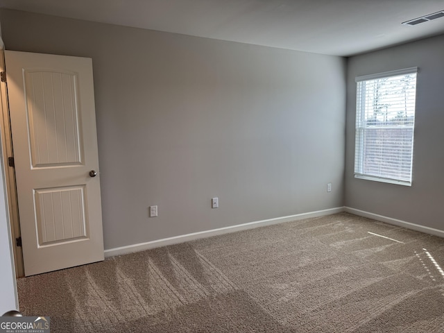 spare room featuring carpet