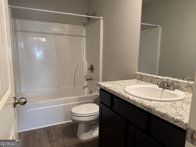 full bathroom with vanity, toilet, shower / bath combination, and hardwood / wood-style floors