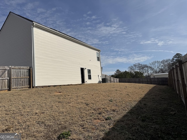 view of property exterior with cooling unit and a yard