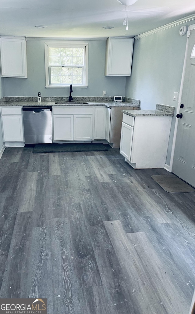 kitchen featuring white cabinetry, stainless steel dishwasher, dark hardwood / wood-style floors, and sink