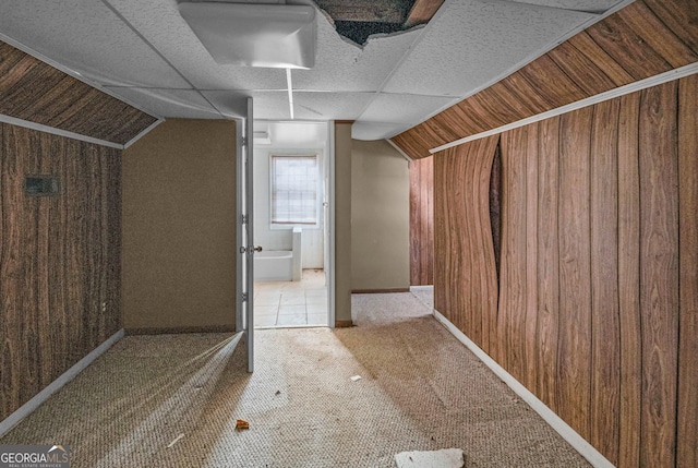 bonus room featuring lofted ceiling and wood walls