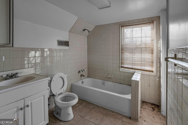 bathroom with lofted ceiling, vanity, toilet, and tile walls