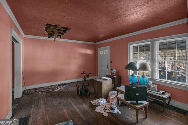 interior space featuring ornamental molding, wood-type flooring, and a textured ceiling