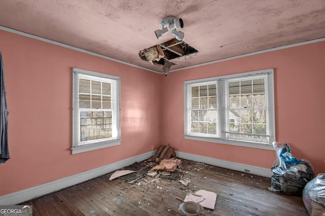 interior space with hardwood / wood-style floors and ornamental molding