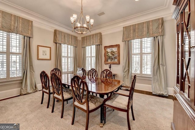 dining area with a notable chandelier, crown molding, and a wealth of natural light