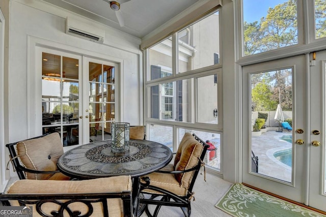 sunroom / solarium featuring french doors, a wealth of natural light, and an AC wall unit