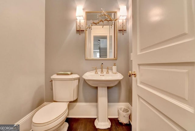 bathroom with wood-type flooring and toilet