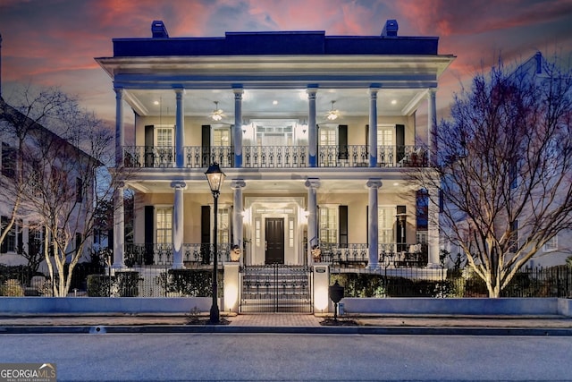 view of front facade featuring a balcony and ceiling fan