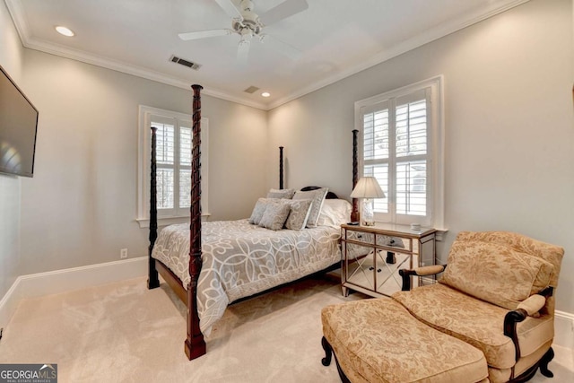 carpeted bedroom featuring crown molding and ceiling fan