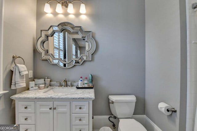 bathroom featuring vanity and toilet