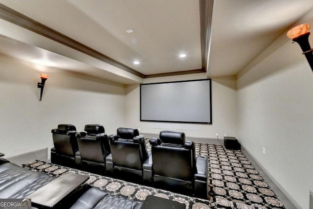 home theater room featuring crown molding and a raised ceiling