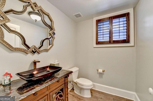 bathroom featuring vanity and toilet