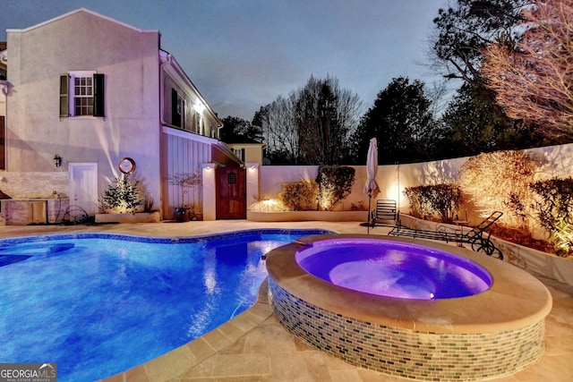 view of swimming pool with an in ground hot tub and a patio