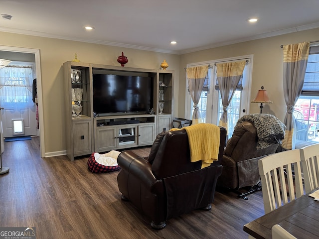 living room with dark wood-type flooring, ornamental molding, and a wealth of natural light