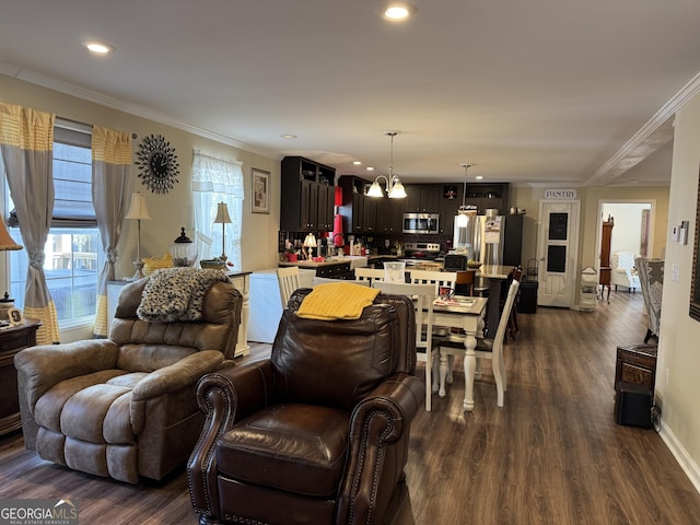 living room with ornamental molding, dark hardwood / wood-style flooring, and a notable chandelier