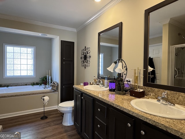 full bathroom with hardwood / wood-style floors, independent shower and bath, vanity, toilet, and crown molding