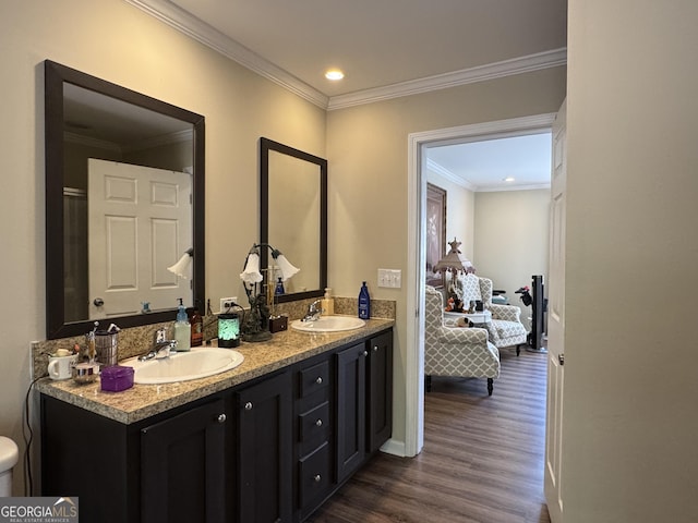 bathroom with vanity, hardwood / wood-style floors, and crown molding