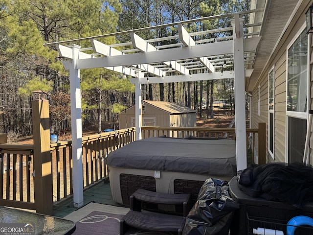 deck featuring a storage shed, a pergola, and a hot tub