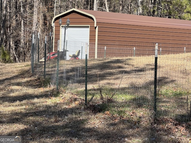 view of yard featuring an outbuilding and a garage