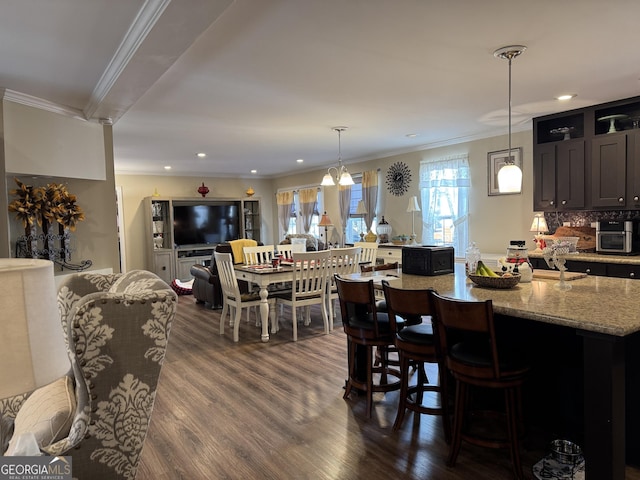 dining room with dark wood-type flooring and crown molding