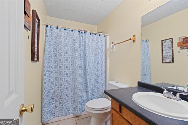 bathroom with vanity, tile patterned floors, a textured ceiling, and toilet