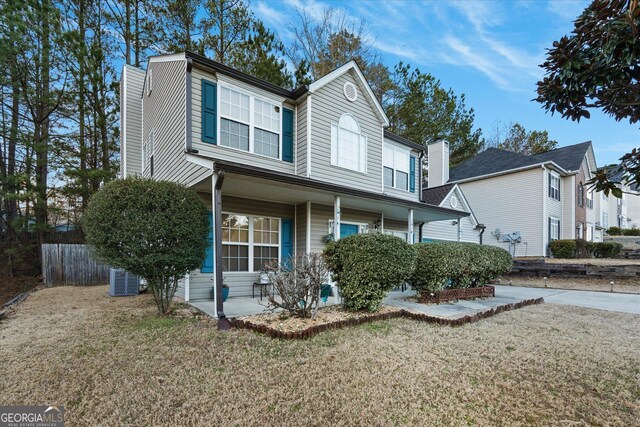 view of front of home with covered porch and a front yard