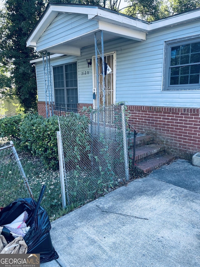 view of exterior entry featuring a porch