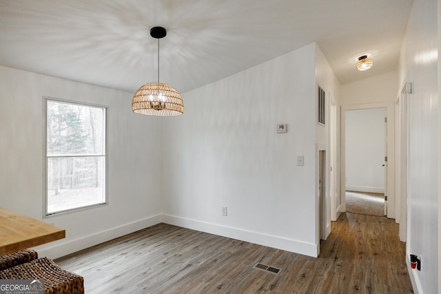 unfurnished dining area featuring hardwood / wood-style floors