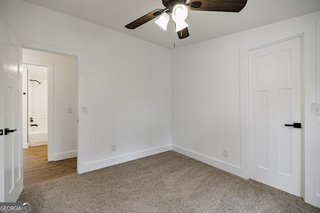 empty room featuring carpet floors and ceiling fan