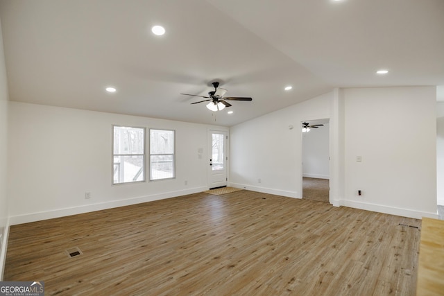 unfurnished living room featuring ceiling fan, lofted ceiling, and light hardwood / wood-style flooring