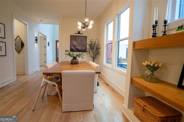 dining room with an inviting chandelier and light wood-type flooring