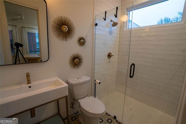 bathroom featuring sink, toilet, and walk in shower