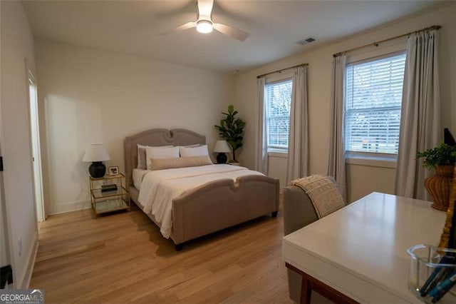 bedroom with ceiling fan and light wood-type flooring