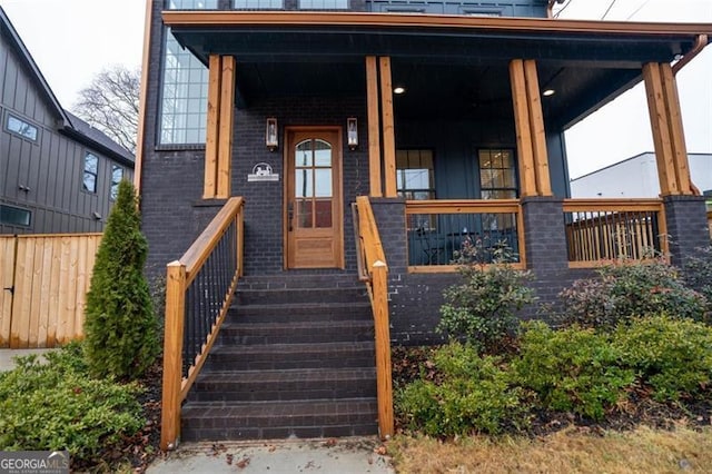 view of exterior entry with covered porch