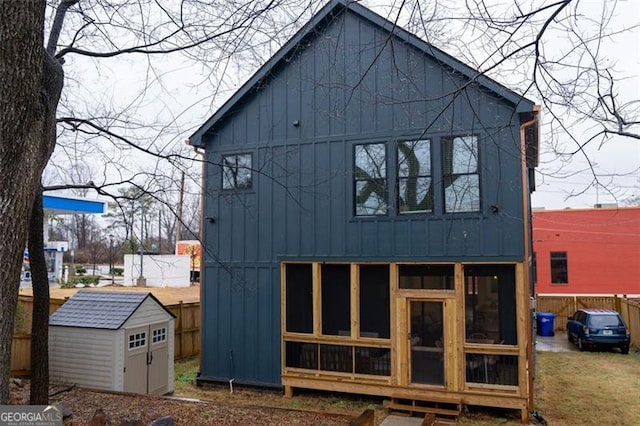 back of house featuring a storage unit