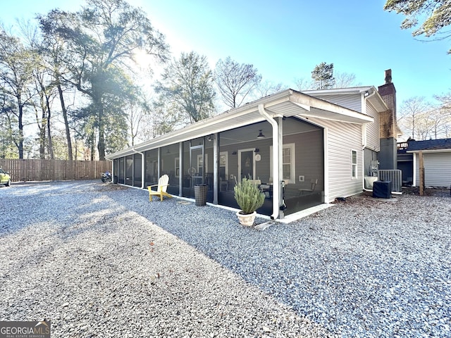 back of house with a sunroom and central AC unit